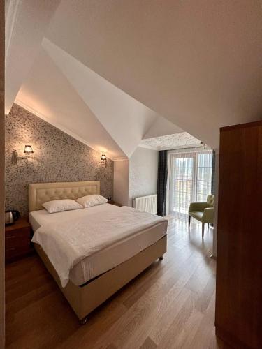 a bedroom with a large bed in a room with an attic at Akpinar Hotel in Uzungöl