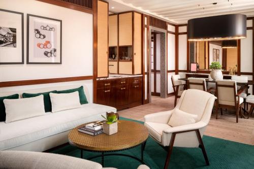 a living room with a couch and a table at Portrait Milano - Lungarno Collection in Milan