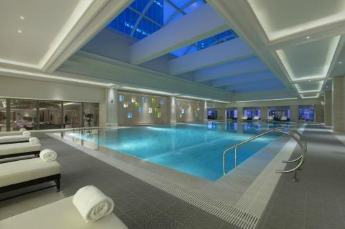 a large swimming pool in a hotel room at The Westin Qingdao - Instagrammable in Qingdao