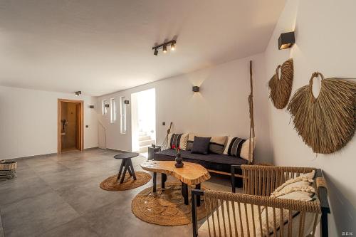 a living room with a couch and a table at Le Palme Mykonos in Klouvas