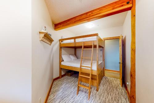 a bedroom with bunk beds in a tiny house at Snow Leopard's Retreat in Big White