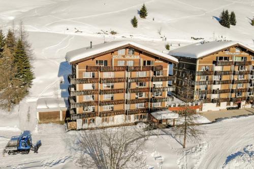 an aerial view of a hotel in the snow at Valaisia 145 in Riederalp
