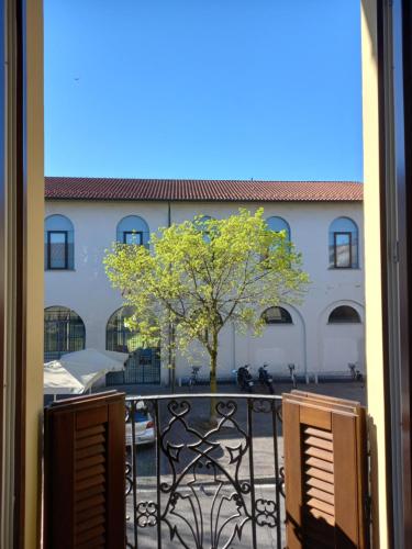 a view from a window of a building with a tree at Vivila - Ca' Foulard in Cernusco sul Naviglio