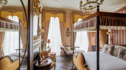 a bedroom with a canopy bed and a living room at Henrys Townhouse Marylebone, London in London