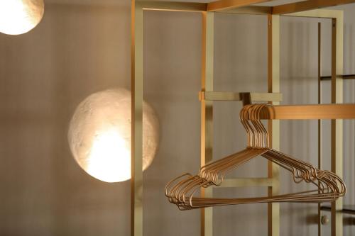 a couple of lights are hanging on a wall at Brilliance of Mykonos in Glastros