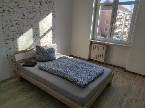 a bedroom with a bed in a room with a brick wall at Beautiful apartments in the city of zeitz in Zeitz