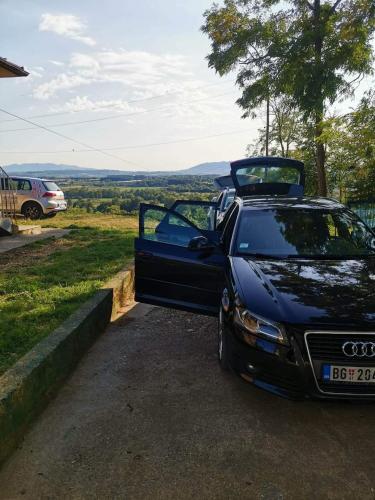 a car parked in a driveway with its door open at Šumadijska panorama in Topola