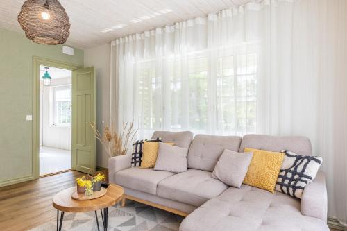 a living room with a couch and a large window at Kalakuninga Puhkemaja in Liimala