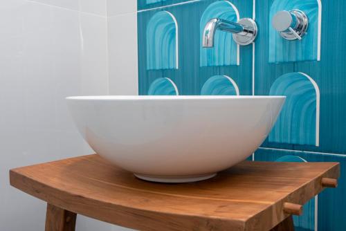 a white bowl sitting on a wooden table in a bathroom at Relais al Castello in Castellammare di Stabia
