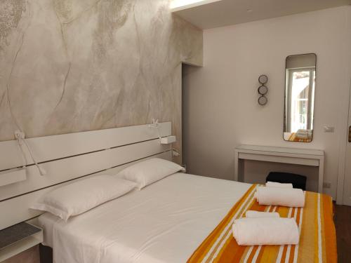 a bedroom with a bed with two white pillows at Luxury Berto Home in Taormina