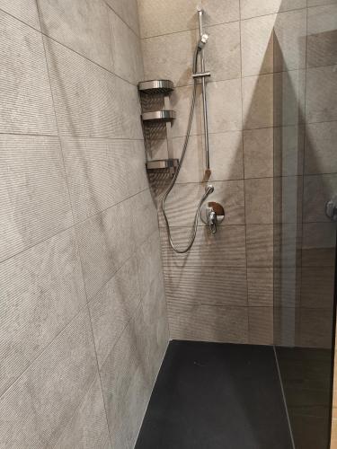 a bathroom with a shower with a shower head at Luxury Berto Home in Taormina