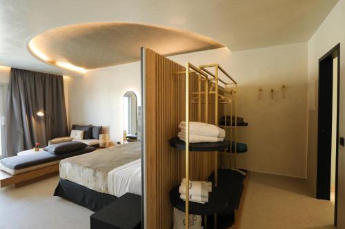 a hotel room with a bed and a bed and a room at Brilliance of Mykonos in Glastros