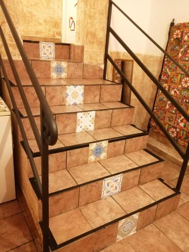 a set of stairs in a room with tiles at B&B Sikelia in Terrasini