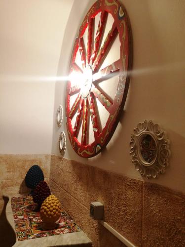 a large red clock on the wall in a room at B&B Sikelia in Terrasini