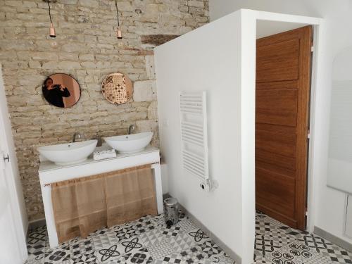 a person taking a picture of a bathroom with two sinks at Maison Laurenza/ La Liversoise in Saint-Jean-de-Liversay