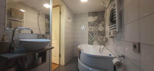 a bathroom with a sink and a tub in it at Loft style apartments in Kaunas center in Kaunas