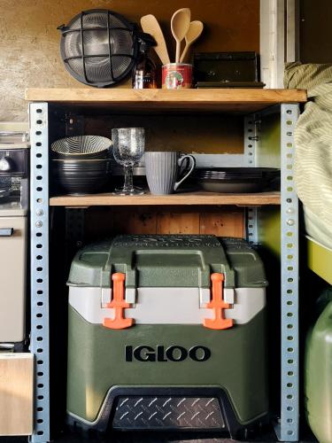 a coffee maker on a shelf in a kitchen at Glamp in Style in a Converted Army Truck in Battle