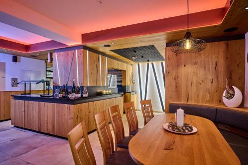 a dining room with a wooden table and chairs at Landhotel Geyer in Kipfenberg