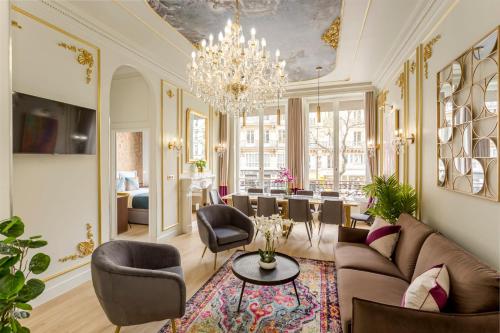 een woonkamer met een bank, stoelen en een kroonluchter bij Luxury 5 Bedroom 4 Bathroom - Louvre & Notre Dame in Parijs
