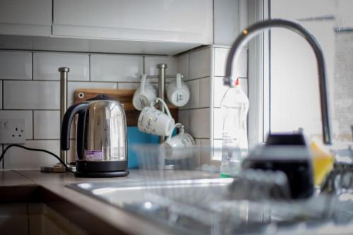 a kitchen counter with a toaster and a sink at The Royalty in Sunderland