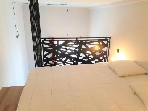 - une chambre avec un lit blanc et une tête de lit noire dans l'établissement Duplex centre mer 403, à Nice