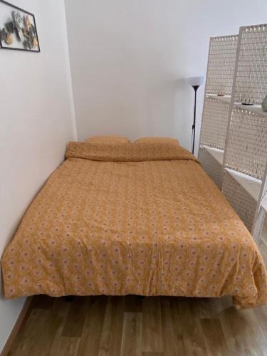 - une chambre avec un lit et une couette en orange dans l'établissement Le Belfort 1 Studio lumineux quartier historique les halles, à Narbonne