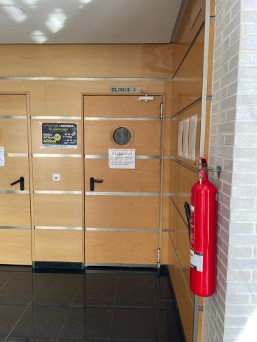 a red fire hydrant in a room with wooden cabinets at NATUR Spa in Villanueva de Río Segura