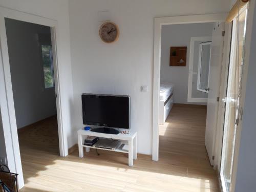 a living room with a television on a table at Casa Vitalis in Vilamarxant