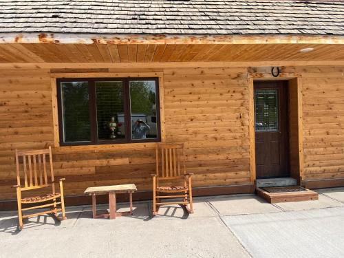 a cabin with two chairs and a table and a window at Creekside Downtown Vacation Suites, Only Adults 25 or older in Buffalo