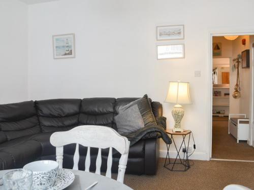 a living room with a black couch and a table at Apartment 1 - Uk44165 in Bridlington