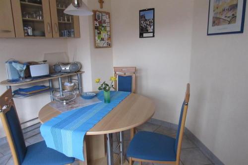 a table and chairs with a blue table cloth on it at Ferienwohnung Wilhelmi in Saarburg