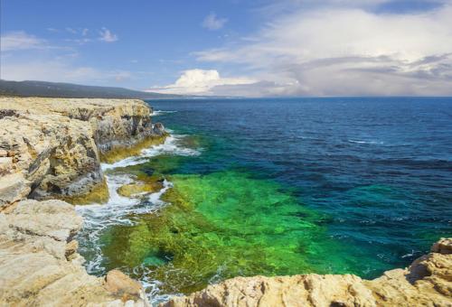 an aerial view of the ocean near a rocky shore at Palm garden paradise in Pervolia