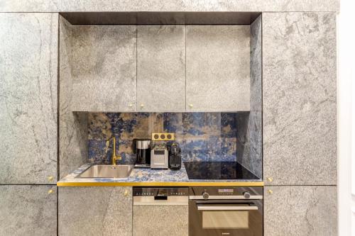 a kitchen with a sink and a counter top at Luxury 5 Bedroom 4 Bathroom - Louvre & Notre Dame in Paris