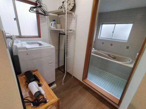 a bathroom with a shower and a sink and a tub at Nishi-Shinjuku 3LDK SJ0243 in Tokyo