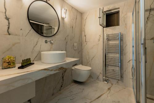 a bathroom with a sink and a mirror at Dafni Villa a place to visit in Orné