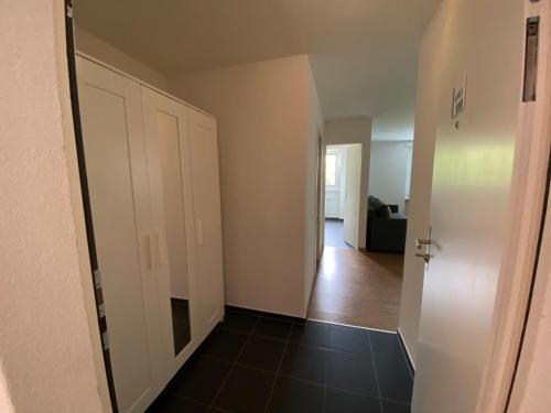 an empty room with a door and a hallway at Galaxy Apartments Lucerne in Luzern