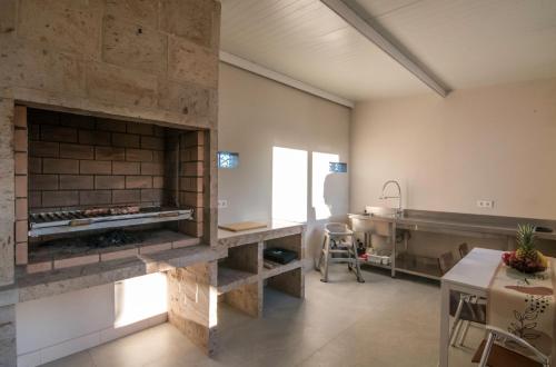 cocina con chimenea de piedra en una habitación en Villa las sinas 2 - As Sinas - Pontevedra, en Villanueva de Arosa