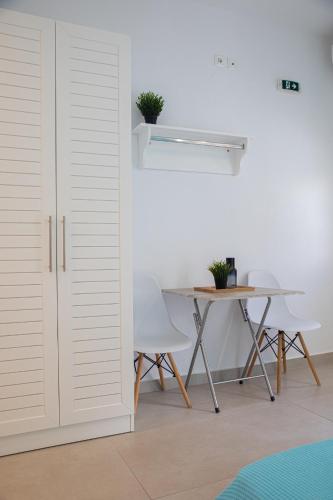 a room with a table and chairs and a door at Central Apartments in Stavros