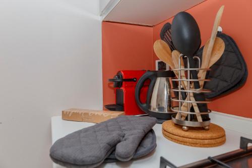 a kitchen counter with a coffee pot and utensils at Residence Villa Ada E203 in Ghiffa
