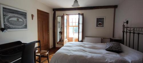 a bedroom with a bed and a piano and a window at HOTEL RURAL LA ENGAÑA in Pedrosa