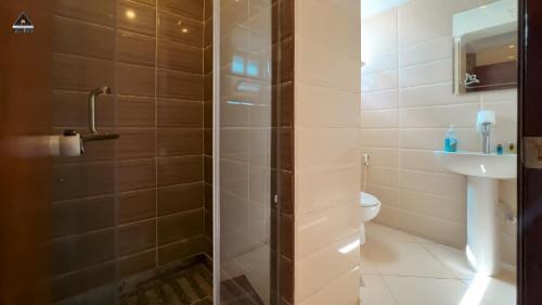 a bathroom with a shower and a toilet at Pyramids Height Hotel & Pyramids Master Scene Rooftop in Cairo