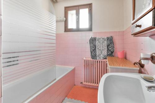 a pink bathroom with a tub and a sink at Appartement de 2 chambres avec balcon amenage et wifi a Courchevel a 6 km des pistes in La Perrière