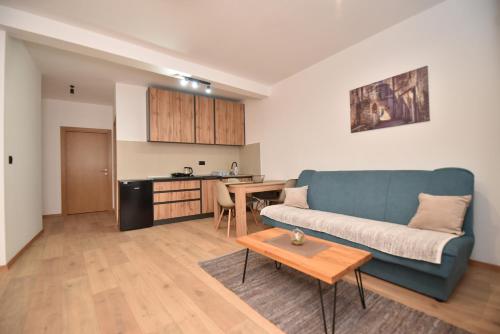 a living room with a couch and a table at VILA PERLA in Trebinje