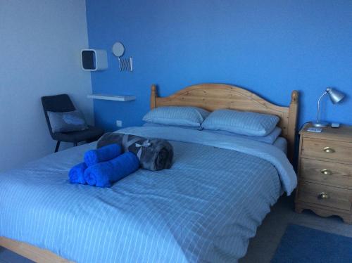 a blue bedroom with a bed with two blue stuffed animals on it at Lapčiči View in Budva