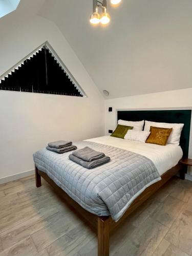 a bedroom with a large bed with towels on it at Emery Street Lodge in Cambridge