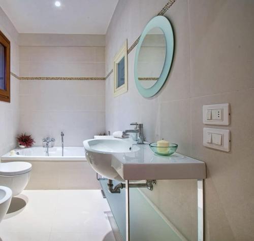 威尼斯Appartamento ACCADEMIA INN的浴室里有洗手池、马桶和镜子。