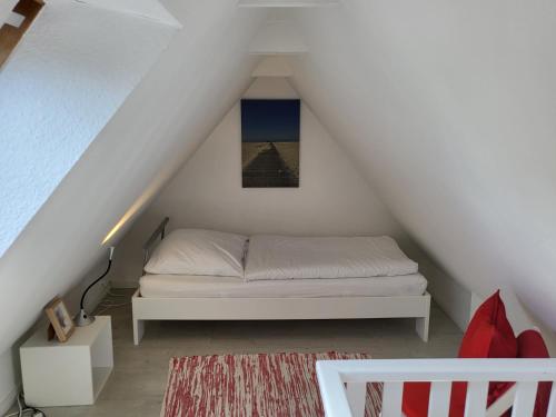 a bedroom with a bed in the attic at Ferienwohnung "Frau Böhl" in Sankt Peter-Ording