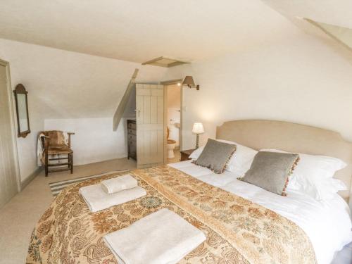 a bedroom with a large bed with two pillows on it at Langstone Farm in Okehampton