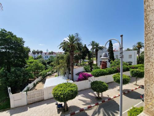 a view of a park with trees and bushes at Large Family Apartment by Beach & center of town in Asilah