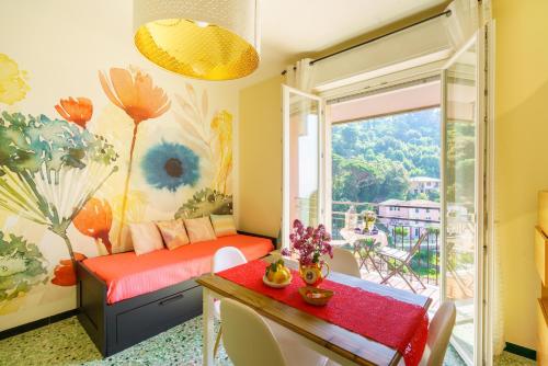 a bedroom with a bed and a table and a window at Costasole in Monterosso al Mare